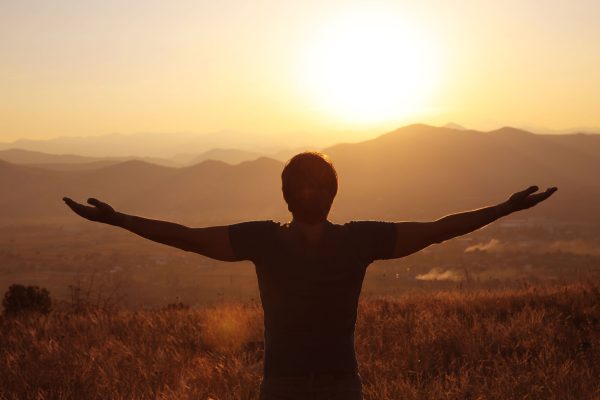 Freedom. Free man with open arms on sunset. success. Travel. Good life.